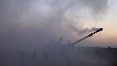 Israeli soldiers fire a 155mm self-propelled Howitzer towards the Gaza Strip from their position along the border, on May 18, 2021. AFP