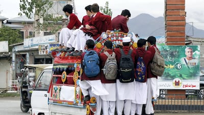 Pupils hitch a ride home from school in Mingora city