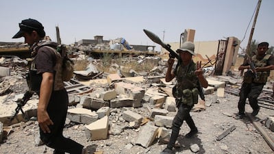Iraqi Shiite fighters from the Popular Mobilisation units deploy in the city of Baiji, north of Tikrit. Ahmad Al Rubaye / AFP