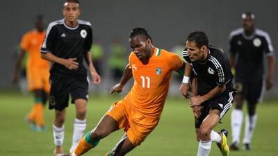 The Libyan players, in black, kept star players, such as Didier Drogba, with ball, and Yaya Toure quiet in Abu Dhabi last night.