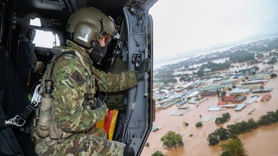 An Australian military helicopter flies over the New South Wales town of Lismore. Photo: AFP