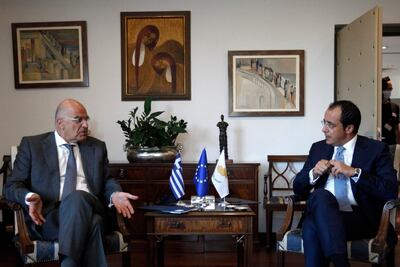 Cyprus Foreign Minister Nikos Christodoulides, right, discusses heightened military tensions with Turkey over its ongoing search for hydrocarbons in the Mediterranean with his Greek counterpart Nikos Dendias, on August 18, 2020. AP Photo