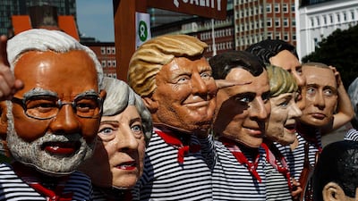Activists from Oxfam wear masks depicting some of the world leaders attending the G20 summit in Hamburg, Germany. Fabrizio Bensch / Reuters