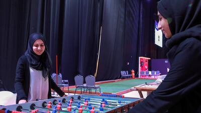 Visitors enjoy a game of foosball at the Ramadan exhibition at Adnec. Victor Besa / The National