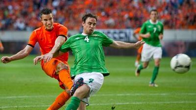 Robin van Persie fights for the ball with Michael Duff