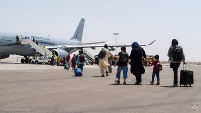 People board a French Air Force plane for an evacuation flight to Paris, where France's government is not recognising the Taliban. AFP