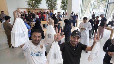 Apple fans with their purchased iPhones at the launch of iPhone XS at Apple store in Dubai Mall.