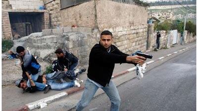 A reader expresses her dissatisfaction with the photo caption that ran with this picture on March 17. In her view, a 'suspect' is not being 'detained', but instead a Palestinian protester is being unjustly beaten.