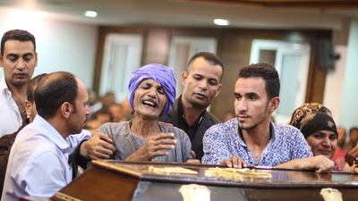 Relatives and friends of Christian Assad Labib react during his funeral at the Anglican Church in Sawaada village near Minya city. AFP