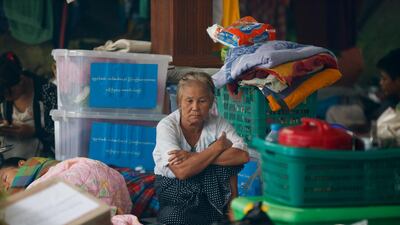 A old woman sits among piled up belongings of residents taking shelter inside a pagoda which is turned into a temporary evacuation center at Hpa-An Township in Kayin State, Myanmar. EPA / LYNN BO BO