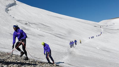 French flanker Yannick Nyanga leads team-mates down the Grande Motte glacier during the French rugby union team's training camp in Tignes, south-east France, before the 2015 Rugby World Cup. AFP