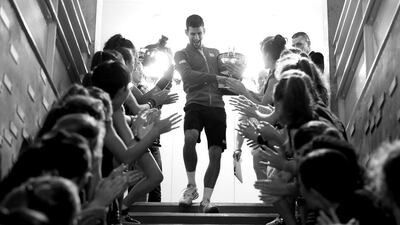 French Open champion Novak Djokovic of Serbia celebrates with the ball girls following his victory against Andy Murray. Clive Brunskill / Getty Images