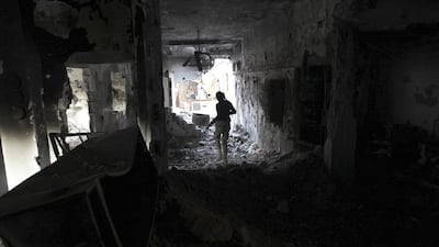 A Free Syrian Army fighter inside a damaged house in Deir Al Zor, eastern Syria. Khalil Ashawi / Reuters