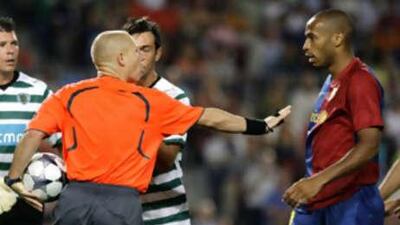 Barcelona's French striker Thierry Henry has words with the referee during Barca's 3-1 Chamions League win over Sporting Lisbon.