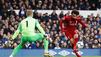 Everton goalkeeper Jordan Pickford saves a shot from Liverpool striker Mohamed Salah at Anfield. Reuters