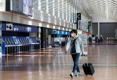A passenger at Haneda Airport in Tokyo, Japan. A new survey suggests that many people expect to be travelling again by July. Courtesy EPA