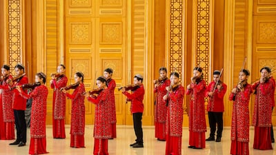 Musicians play the violin during the opening of the renovated Monument of Neutrality in Ashgabat, Turkmenistan, before the 30th anniversary of the country’s neutrality. AFP