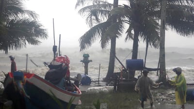 Thai villagers evacuate as high waves are seen in the background during heavy downpours caused by tropical storm Pabuk at a village in Pak Phanang district, Nakhon Si Thammarat province, southern Thailand. EPA