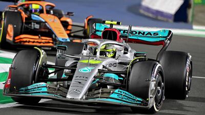 Mercedes' British driver Lewis Hamilton (foreground) and McLaren's British driver Lando Norris (background) drive during the 2022 Saudi Arabia Formula One Grand Prix at the Jeddah Corniche Circuit on March 27, 2022. (Photo by ANDREJ ISAKOVIC / AFP)