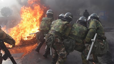 Members of the military police try to destroy a barricade in Sacaba, on the outskirts of Cochabamba, Bolivia, November 15, 2019. Reuters
