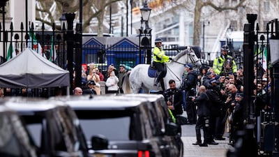 Mounted Metropolitan Police officers with the Syrian presidential motorcade as it leaves Downing Street in London. EPA