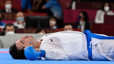Iran's Sajad Ganjzadeh lays motionless after an injury in the men's kumite +75kg final against Saudi Arabia's Tareg Hamedi.