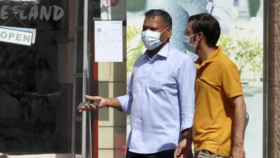 People wearing a protective face mask as a preventive measure against the spread of coronavirus in the Bur Dubai area in Dubai.