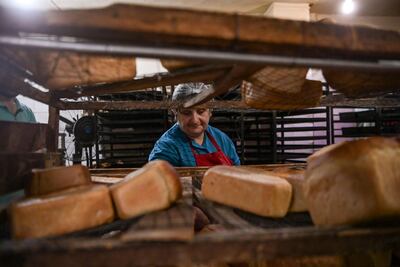 A woman makes bread at a bakery offering free bread to residents in the city of Stepanakert, the largest city in Nagorno-Karabakh, as Azerbaijani forces continue to attack the city. AFP
