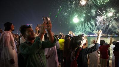 Emiratis, expats, and visitors braved the traffic, parking and silly-string to gather at Abu Dhabi’s Corniche on National Day. Christopher Pike / The National