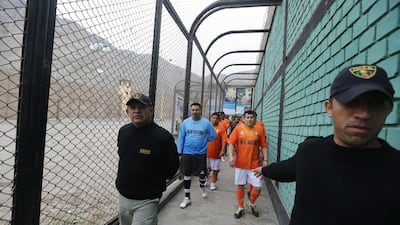 Prisoners, wearing jerseys in the colours of the Netherlands national football team, participate in the opening ceremony of their own version of the 2014 World Cup at the Castro-Castro prison in Lima on Monday. Mariana Bazo / Reuters / June 2, 2014
