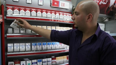 A Jordanian man works in his tobacco store in Amman, Jordan. The National