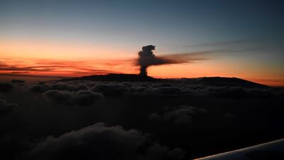 Huge plumes of black-and-white smoke shoot out of the volcano. EPA
