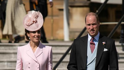 The Duchess of Cambridge wears a Alexander McQueen coat dress with a Juliette Botterill hat, Loeffler Randall clutch, Gianvito Rossi suede pumps and pearl drop earrings that belonged to Princess Diana of Wales for the Royal Garden Party at Buckingham Palace in London on May 21. AP