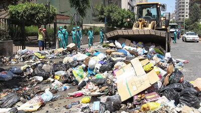 Lebanese street cleaners begin their clean-up operation, collecting rubbish from the streets of Beirut a week after protesters shut down the country's largest landfill leaving piles of uncollected trash all over the Lebanese capital on July 26, 2015. Anwar Amro/AFP Photo