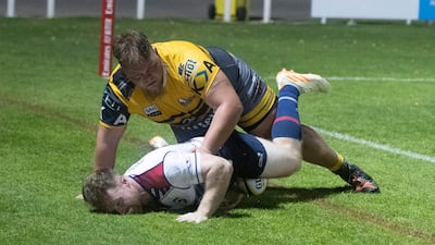 Auletta Elliot of Dubai Hurricanes is tackled.