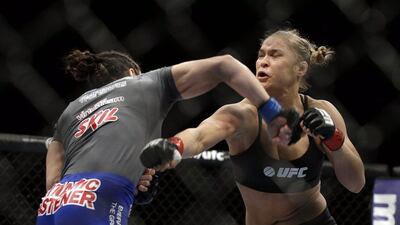 Ronda Rousey, right, and Sara McMann exchange punches during a UFC 170 mixed martial arts women's bantamweight title fight on February. 22, 2014, in Las Vegas. Isaac Brekken / AP Photo