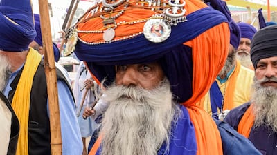 A Nihang (traditional Sikh religious warrior) wearing a giant turban pays his respect on the occasion of the 550th birth anniversary of Guru Nanak Dev at Gurudwara Ber Sahib in Sultanpur Lodhi. AFP