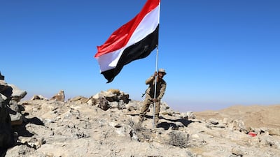 A Yemeni fighter, loyal to the Yemeni government, holds a Yemeni flag at a position during an offensive against Houthi rebels positions in the Nihem region, east of Sana'a, where several Houthi officers were killed. Soliman Al Nowab / EPA