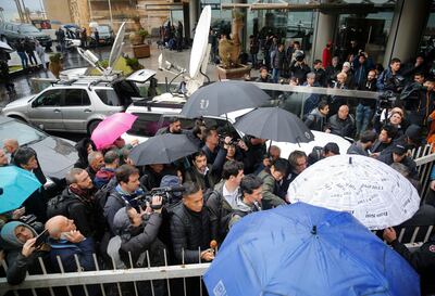 The press lines up to enter the Lebanese Journalists Syndicate building where ex-Nissan chief Carlos Ghosn is scheduled to hold a press conference. AP
