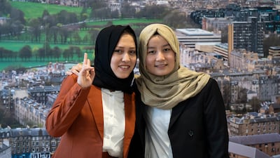 Students Omulbanin Sultani, left, and Zahra Hussaini during a reception at Queen Elizabeth House, Edinburgh, for their arrival in Scotland