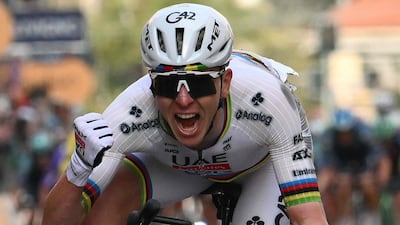 UAE Team Emirate's Slovenian rider Tadej Pogacar celebrates as he crosses the finish line to win the 117th Milan - Sanremo one-day classic cycling race, in Sanremo. AFP