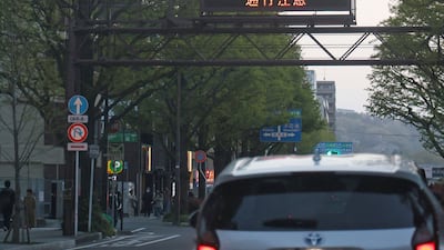 Warnings about the earthquake and potential tsunami are displayed to motorists in Sendai, in Miyagi Prefecture, Japan. AFP