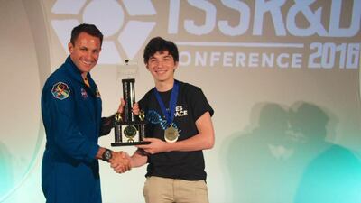 Julian Rubinfien receiving the Genes in Space trophy from astronaut Josh Cassada in San Diego last month. Courtesy Julian Rubinfien