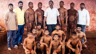 Wrestlers with their coach, Maruti Mane, centre, the Juna Hanuman taleem in Pargaon village of Maharashtra’s Kolhapur district. Sanket Jain for The National