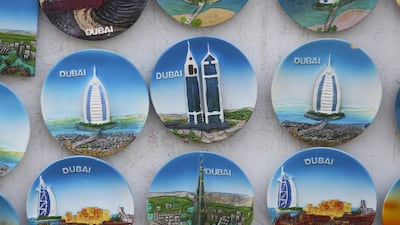 Souvenir fridge magnets sit for sale at a tourist store in Dubai. Chris Ratcliffe / Bloomberg News