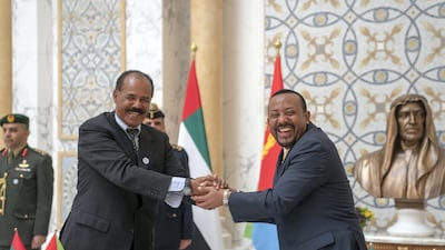 Ethiopian Prime Minister Abiy Ahmed, right, and Eritrean President Isaias Afwerki shake hands at the presidential palace in Abu Dhabi in July. Crown Prince Court - Abu Dhabi