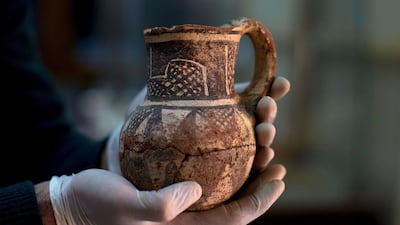 In this Feb. 23, 2016 file photo, Jihad Abu Kahrlah, an archaeologist at Syria's National Museum, holds an artifact delivered from the Daraa Museum to Damascus, Syria. Photo / AP