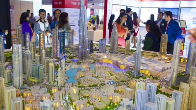 Above, visitors take a look at a mock up at the Dubai Property Show at Mumbai. Subhash Sharma for The National