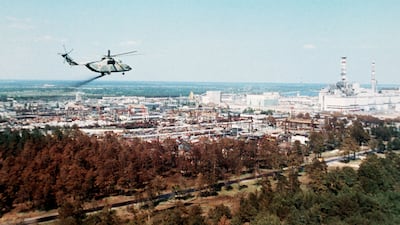 Undated picture of a military helicopter spreading a substance supposed to reduce the contamination of the air full of radioactive elements above the Chernobyl nuclear plant, a few days after its No. 4 reactor's blast. AFP