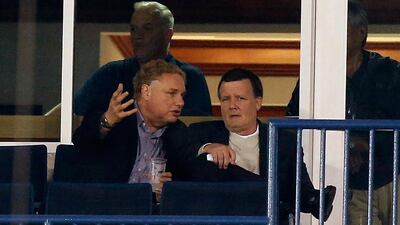 Co-owner Hank Steinbrenner, right, of the New York Yankees talks with team president Randy Levine during a Grapefruit League Spring Training Game against the Atlanta Braves at George M. Steinbrenner Field on March 5, 2013 in Tampa. AFP